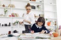 Tutor with litthe girl studying at home Royalty Free Stock Photo