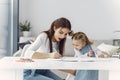 Tutor with litthe girl studying at home Royalty Free Stock Photo