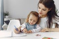 Tutor with litthe girl studying at home Royalty Free Stock Photo