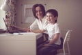 Tutor teach preschooler with laptop, real home Royalty Free Stock Photo