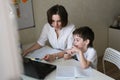 Tutor teach preschooler with laptop, real home Royalty Free Stock Photo