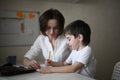 Tutor teach preschooler with laptop, real home Royalty Free Stock Photo