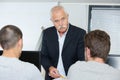 tutor teaching class while two students listening Royalty Free Stock Photo