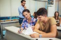 Tutor teaching university students in classroom Royalty Free Stock Photo