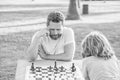 tutorship. dad and kid play logic game. father and son playing chess at table