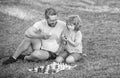tutorship. daddy and child play logic game. father and son playing chess on grass in park.