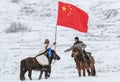 Tuva men competing in a horse racing competition in the Altai mountains in China