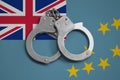 Tuvalu flag and police handcuffs. The concept of observance of the law in the country and protection from crime