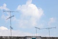 TV Antenna on the roof with blue sky and cloud background