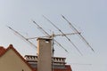 Tv antenna on roof of home. Technology of broadcast television and radio on rooftop. Signal receiver. Tower of transmit media.