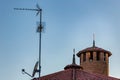 TV antenna, satellite dish and Catholics Cross Royalty Free Stock Photo