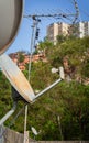 tv antennas on the roof of a building overlooking a latin neighborhood