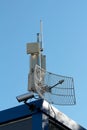 TV antennas with transmitters and closed circuit TV CCTV security camera mounted on pole on top of industrial complex building Royalty Free Stock Photo