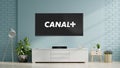 Modern living room and television with Canal+ logo on flat screen