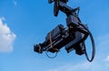 TV camera on the operator crane. Camcorder on a background of blue sky