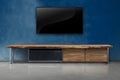 Tv on color concrete wall with wooden table interior vintage stye