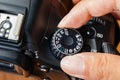 Tv dial mode on dslr camera with fingers on the dial Royalty Free Stock Photo