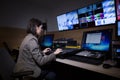 TV director at editor in studio. TV director in a television broadcast gallery.Woman producer sat at a vision mixing panel Royalty Free Stock Photo