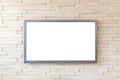 TV display on modern brick wall background with white screen Royalty Free Stock Photo