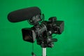 TV Film Camera with Shotgun Mic Green Screen Background