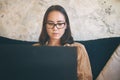 The tv gets closer and closer each day. a young woman using a laptop on the sofa at home. Royalty Free Stock Photo