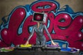 Tv head woman and graffiti wall dj
