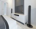 TV and music speakers in modern light bedroom.