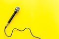 TV news concept. Microphone on yellow background top-down copy space Royalty Free Stock Photo