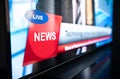 Tv news live broadcast and production concept. Breaking newscast on television. Screen close up of logo mockup, headline text. Royalty Free Stock Photo