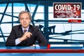 TV News screen with male anchorman reporting latest news on the novel pandemic coronavirus Covid-19 Royalty Free Stock Photo