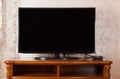 TV is off which is located in a in the modern living room. 3d rendering. Black color tv