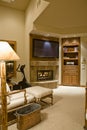 TV Over Fireplace With Reclining Chair In Foreground