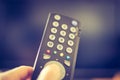 Male hand is holding TV remote control, smart TV Royalty Free Stock Photo