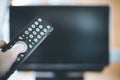 Male hand is holding TV remote control, smart TV Royalty Free Stock Photo