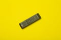 TV remote control  on a yellow background. Cinema, entertainment, TV concept Royalty Free Stock Photo