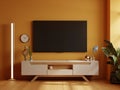 TV room in yellow wall background,Modern living room decor with a tv wooden cabinet Royalty Free Stock Photo