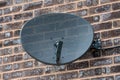 TV satellite dish on a brick wall Royalty Free Stock Photo