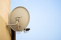 Tv satellite dish on the home wall in the city in urban area on Royalty Free Stock Photo