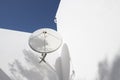 TV Satellite dish on the wall of a white house Royalty Free Stock Photo