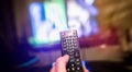 Tv Screen in Living room with remote control in hand. motion blur effect Royalty Free Stock Photo