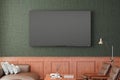 TV screen mockup on the green wall with classic wooden decoration  in living room. Front view, clipping path around screen Royalty Free Stock Photo