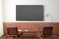 TV screen mockup on the white wall with classic wooden decoration  in living room. Front view, clipping path around screen Royalty Free Stock Photo