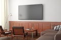 TV screen mockup on the white wall with classic wooden decoration  in living room. Side view, clipping path around screen Royalty Free Stock Photo