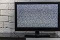 Tv screen with noise glitcher effect. No signal or no communication concept with rustic or loft style innterior. Royalty Free Stock Photo