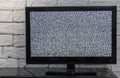 Tv screen with noise glitcher effect. No signal or no communication concept with rustic or loft style innterior. Royalty Free Stock Photo