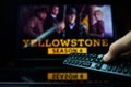 TV series Yellowstone and TV remote controler. TV show Yellowstone is made by Paramount Network