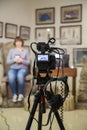 TV shooting at the Museum. LCD monitor on the camcorder. The girl in front of the camera. A record of the interview Royalty Free Stock Photo