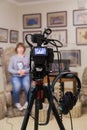 TV shooting at the Museum. LCD monitor on the camcorder. The girl in front of the camera. A record of the interview