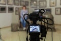 TV shooting at the Museum. LCD monitor on the camcorder. The girl in front of the camera. A record of the interview Royalty Free Stock Photo