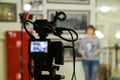 TV shooting at the Museum. LCD monitor on the camcorder. The girl in front of the camera. A record of the interview Royalty Free Stock Photo